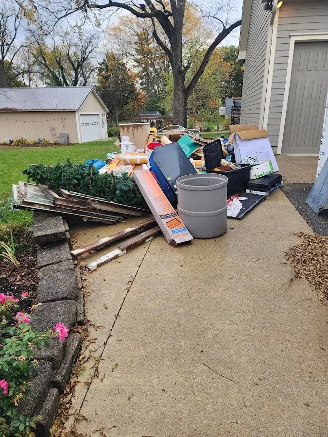 Dumpster being loaded with debris for 12 Yard Dumpster Rental in Calverton